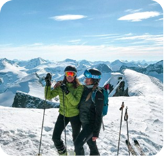 Travellers skiing in snow-covered mountains